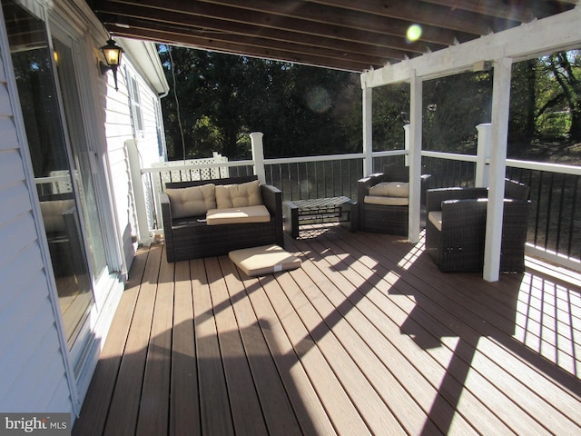 wooden terrace with an outdoor living space