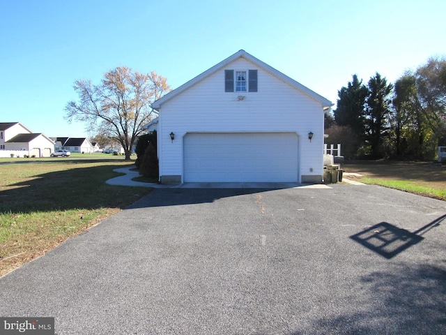 view of side of home with a garage and an outbuilding