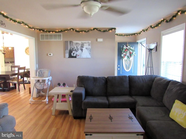 living room featuring ceiling fan and light hardwood / wood-style floors