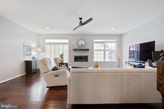 living room featuring dark hardwood / wood-style floors and ceiling fan