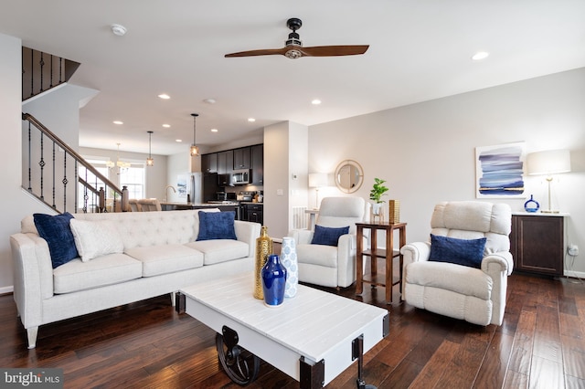 living room featuring ceiling fan and dark hardwood / wood-style floors