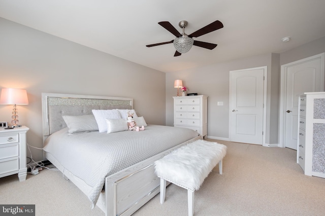 bedroom featuring ceiling fan and light colored carpet