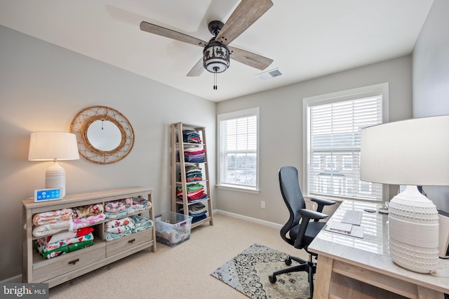 carpeted office space featuring ceiling fan