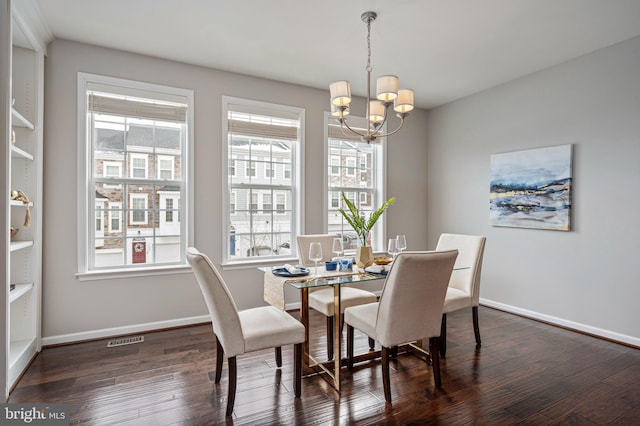 dining room featuring an inviting chandelier and dark hardwood / wood-style floors