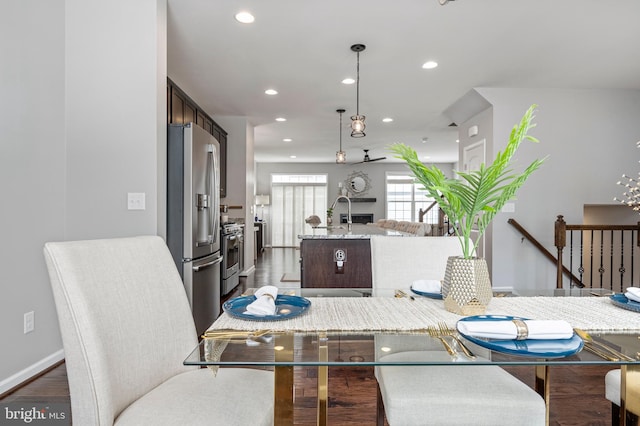 dining room with sink and dark hardwood / wood-style flooring