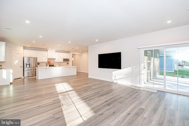 unfurnished living room featuring light wood-type flooring