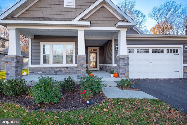 craftsman house with a porch and a garage