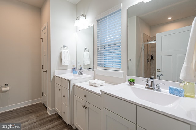 bathroom featuring wood-type flooring, vanity, and a shower with door