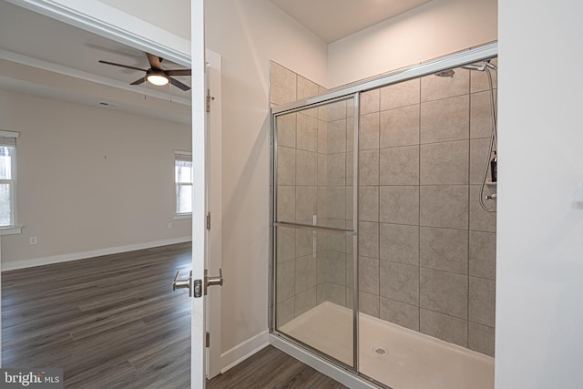 bathroom featuring hardwood / wood-style flooring, ceiling fan, and a shower with shower door