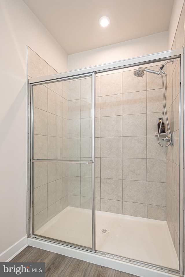 bathroom with hardwood / wood-style floors and walk in shower