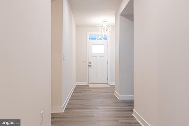 entryway featuring a chandelier and light hardwood / wood-style floors