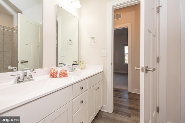 bathroom with hardwood / wood-style floors and vanity