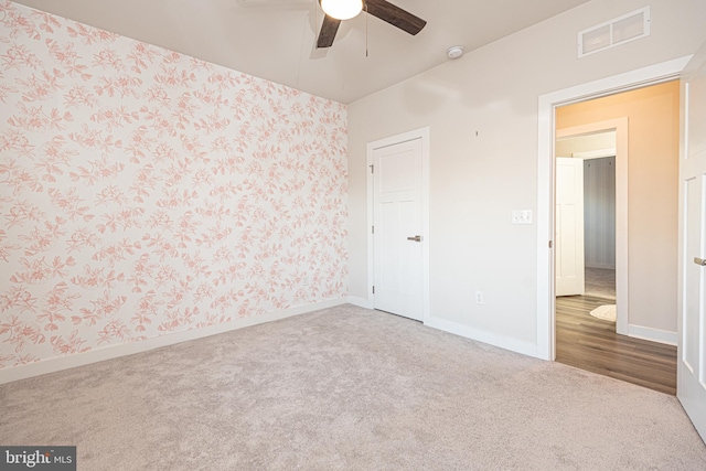 unfurnished bedroom featuring carpet flooring, ceiling fan, and a closet