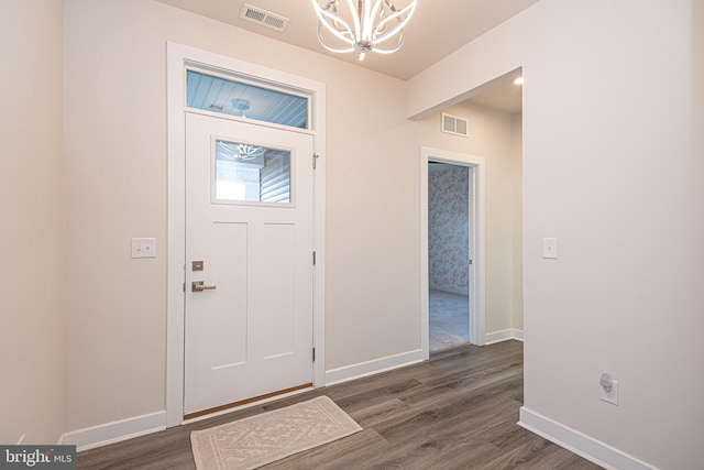 foyer entrance featuring a chandelier and dark hardwood / wood-style flooring