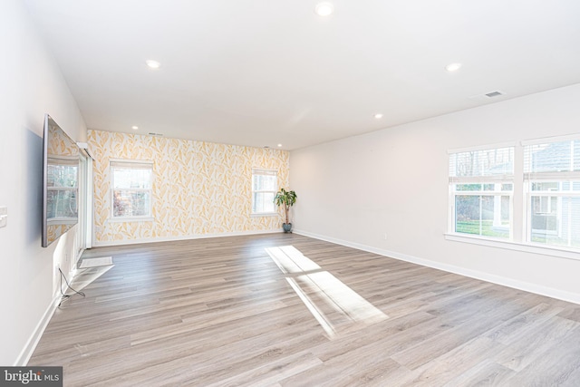 unfurnished room with light wood-type flooring