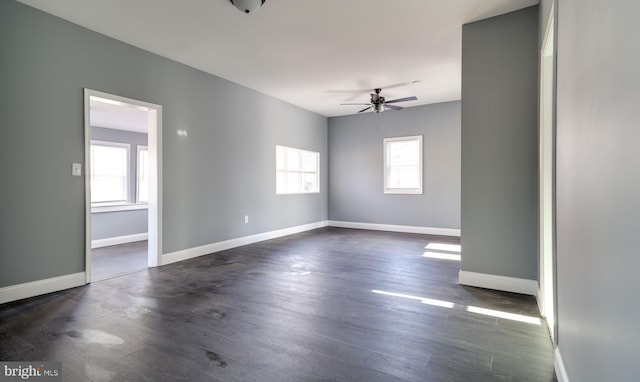 spare room featuring ceiling fan and dark hardwood / wood-style flooring