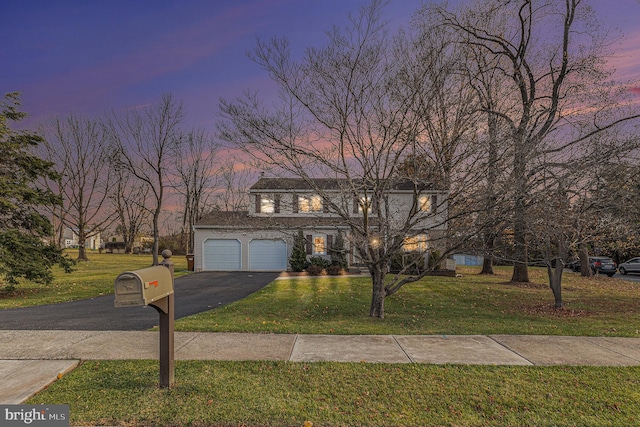 view of front facade with a garage and a lawn