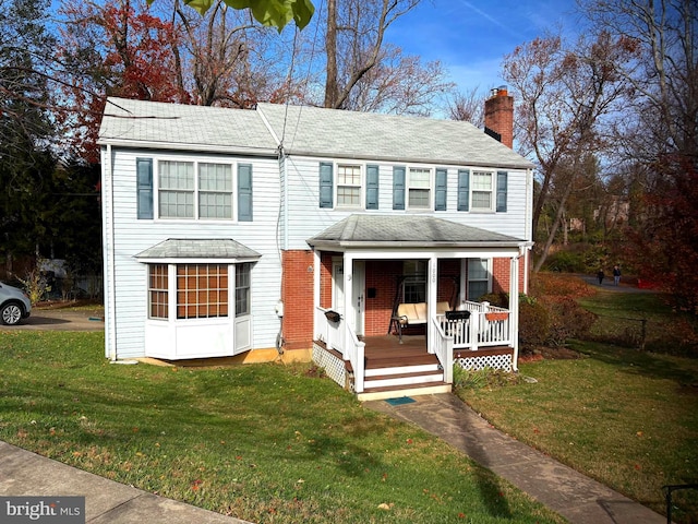 view of front of house featuring a front lawn and covered porch