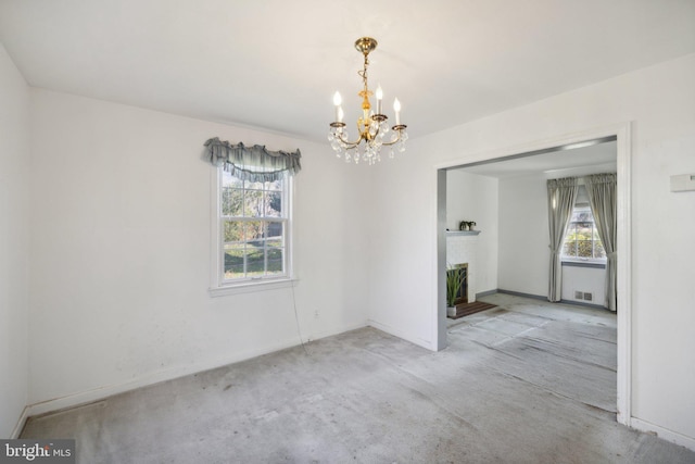 empty room featuring a chandelier and light carpet