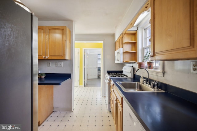 kitchen featuring white appliances and sink