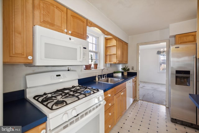 kitchen featuring white appliances and sink