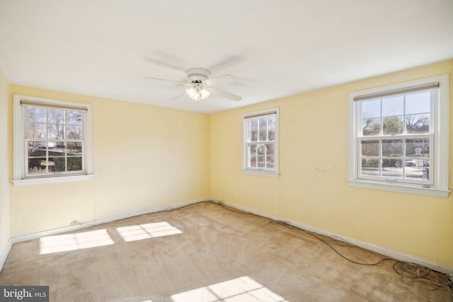 spare room with carpet flooring, plenty of natural light, and ceiling fan