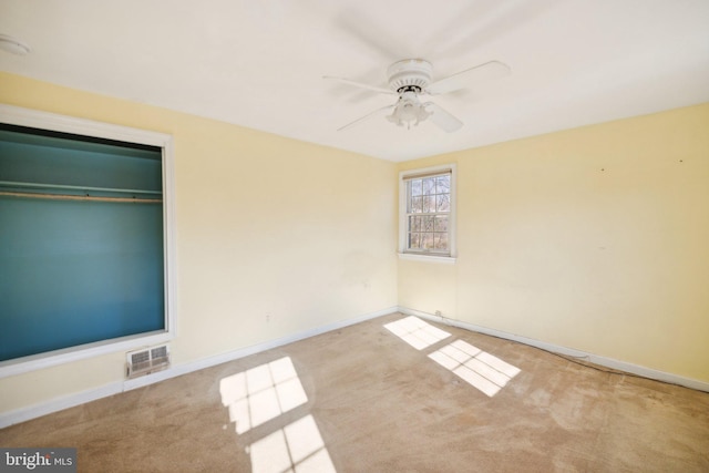 unfurnished bedroom with ceiling fan, a closet, and light carpet