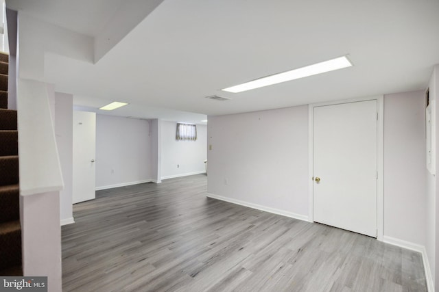 basement featuring light wood-type flooring