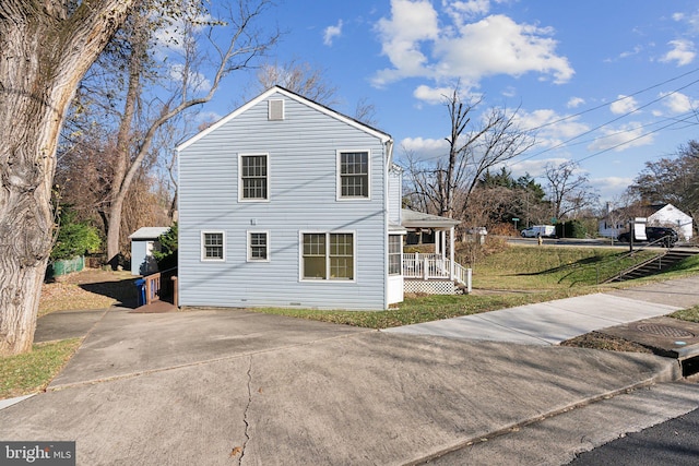 view of property exterior featuring a yard and covered porch