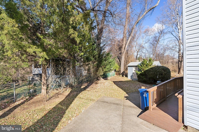 view of yard featuring a shed and a wooden deck