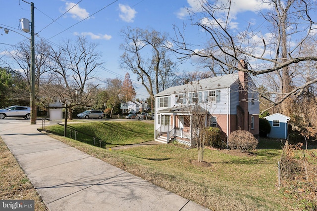 view of side of home featuring an outbuilding and a yard