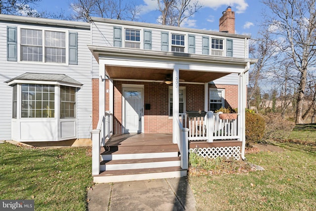 view of front facade featuring covered porch and a front yard