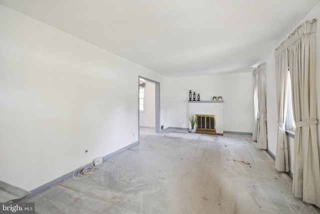 unfurnished living room featuring a brick fireplace