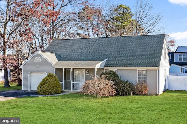 new england style home featuring covered porch, a garage, and a front lawn