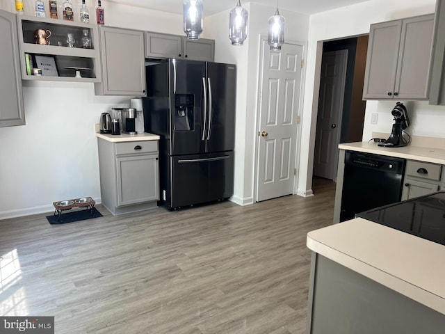 kitchen with refrigerator with ice dispenser, black dishwasher, gray cabinetry, and hanging light fixtures