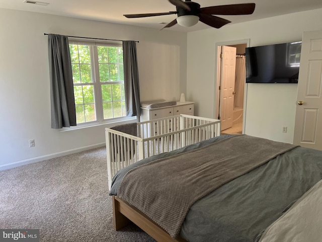 carpeted bedroom with connected bathroom and ceiling fan