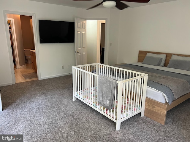 unfurnished bedroom with carpet flooring, ceiling fan, and connected bathroom