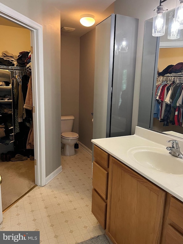 bathroom featuring vanity and toilet