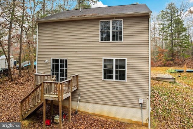 rear view of property featuring a deck