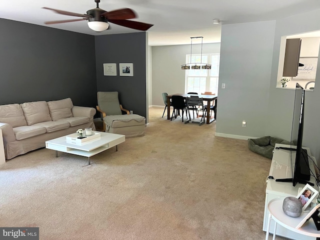 living room featuring light carpet and ceiling fan