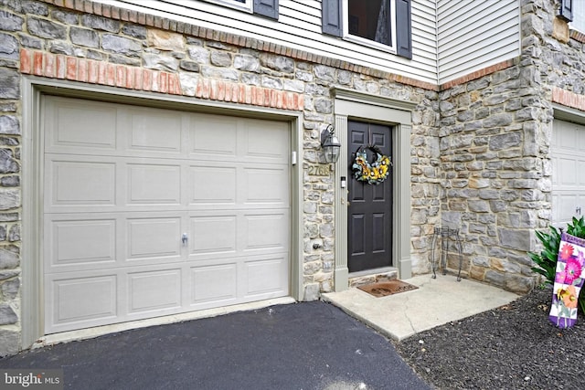 doorway to property featuring a garage