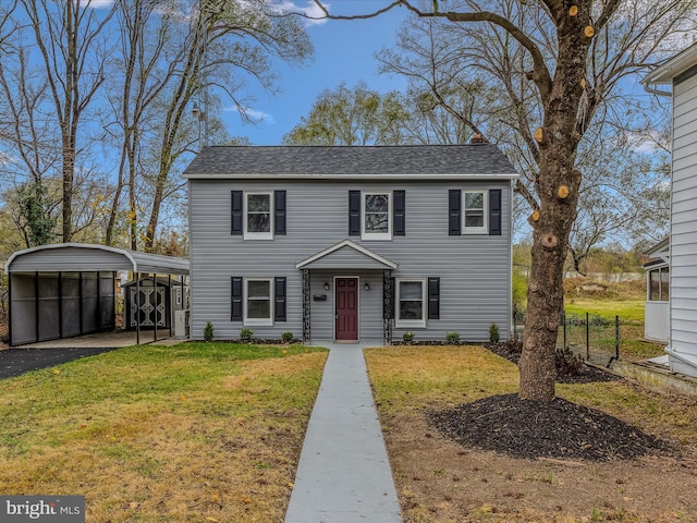 view of front of home featuring a front yard and a carport