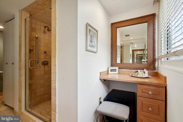 bathroom with a shower with door and tile patterned flooring