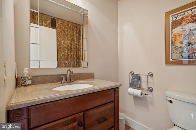 bathroom featuring vanity and toilet