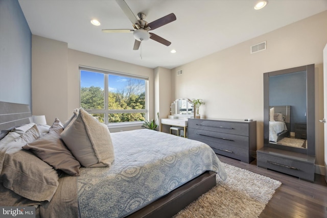 bedroom with ceiling fan and dark wood-type flooring