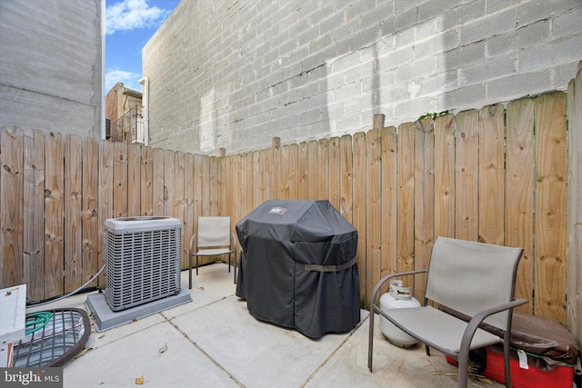 view of patio / terrace featuring central air condition unit and a grill