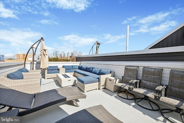 view of patio featuring an outdoor living space with a fire pit