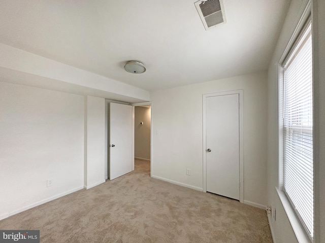 unfurnished bedroom featuring light colored carpet