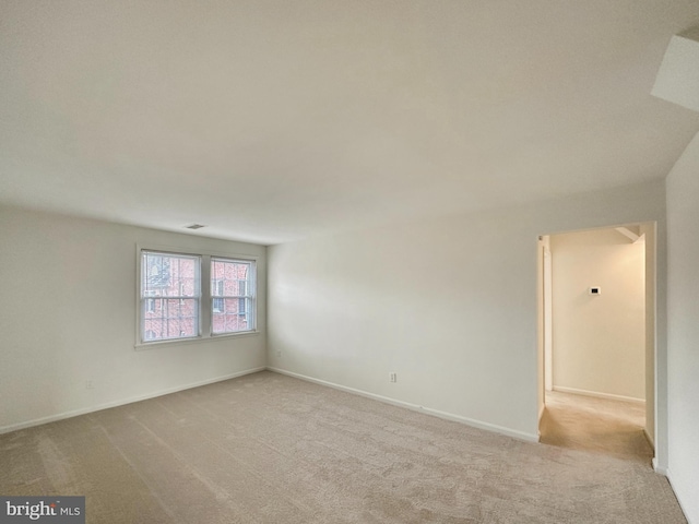 unfurnished room with light colored carpet