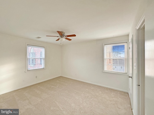 unfurnished room featuring ceiling fan and light colored carpet